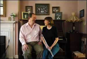 Lee and Amy Heritage, pictured at their home in Toledo. Lee Heritage is a composer and professor of composition at UT and Amy Heritage is a second flutist in the Toledo Symphony.