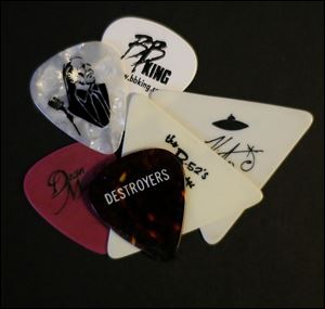 Guitar picks from Willie Nelson, BB King, The B52's, and Destroyers in Steve Niemiec's collection of memorabilia he has acquired.