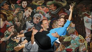 Dancers Michael Lang and Lisa Mayer in front of a mural at the Valentine Theater, 