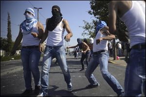 Palestinians throw rocks as they clash with Israeli security forces during the funeral of 16-year-old Mohammed Abu Khdeir in Jerusalem.