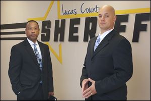 Lucas County sheriff’s deputies Charles Johnson, left, and Damian Worthy are two members of a new initiative that focuses on helping addicts seek treatment. The deputies work with the families of addicts and make house calls on people who are on record as having overdosed in the past year.