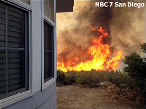 Flames near a home near the San Diego County mountain town of Julian in Southern California.