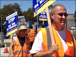 Truck drivers and supporters picket outside the offices of Green Fleet Systems in Carson, Calif., on Monday, July 7, 2014.