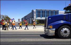 Truck drivers and supporters picket outside the offices of Green Fleet Systems in Carson, Calif.