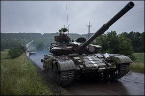 Ukrainian tanks roll to the base in Devhenke village, Kharkiv region, eastern Ukraine, Monday.