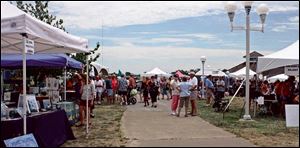 Festivalgoers enjoy the arts and crafts show during a past festival.