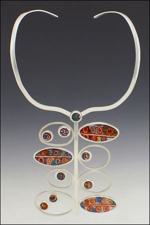L. Sue Szabo of Sylvania Township won the collector’s award for her necklace, ‘‍Strange Fruit.’ Part of the Wasserman show, it’s glass fused to sterling silver.
