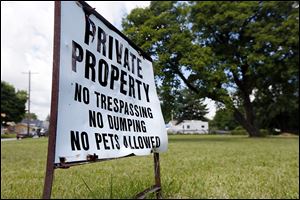  A sign sets down rules on a vacant lot at F Street and Saint John Avenue in North Toledo. The patrol said area residents will have to report tall weeds or rubbish.