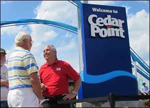 In a 2014 photo, Matt Ouimet, chief executive of Cedar Fair Entertainment Co., greets a guest at Cedar Point amusement park in Sandusky, Ohio.