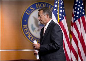 House Speaker John Boehner of Ohio, leaves a news conference earlier today on Capitol Hill in Washington.