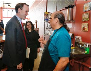 Ed FitzGerald, Democratic candidate for governor, left, meets with Jackie David and her husband Sargis David at their Original Sub Shop on Broadway Street in South Toledo.