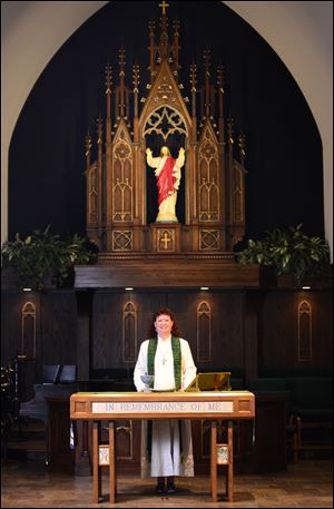 Reverend Ann Marshall stands for a portrait inside Zoar Lutheran Church in Perrysburg, Ohio.