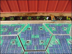 A prototype solar-panel parking area stands at the Solar Roadways business in Sandpoint, Idaho. Scott Brusaw's idea for solar-powered roads has gone viral and raised more than $1.4 million in crowdsourced funding.