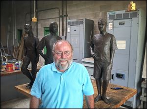 University of Toledo professor Tom Lingeman stands beside his sculptures from the Juvenile Justice Center in Toledo. He is a semifinalist to create a sculpture of Thomas Edison for the U.S. Capitol.