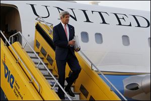 U.S. Secretary of State John Kerry steps out his plane upon arrival at Vienna International Airport for talks with foreign ministers from the six nations negotiating with Tehran on its nuclear program.