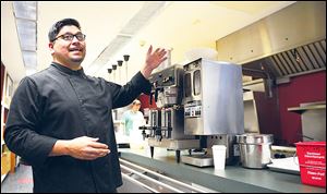 Chef Ruiz explains the features of the museum cafeâs kitchen.