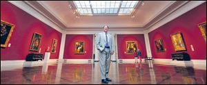 Toledo Museum of Art curator Lawrence Nichols stands in the Great Hall.