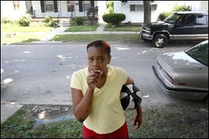 Brasia Lee, 11, discusses the most recent shooting that occurred on her family’s block on East Streicher Street over the weekend in North Toledo. Four teens were shot on East Streicher. Brasia was 9 years old when she was shot in her right leg two years ago.