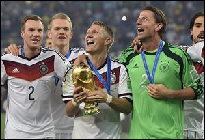 Germany's Bastian Schweinsteiger celebrates with the trophy after the World Cup final soccer match between Germany and Argentina on Sunday at the Maracana Stadium in Rio de Janeiro, Brazil.
