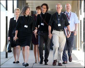 The Archbishop of Canterbury, Justin Welby, second right, and unidentified members of the clergy, arrive for the General Synod meeting today at The University of York, in York England.