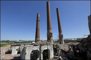 The downtown Toledo skyline is visible behind the remains of the Toledo Edison Acme power plant in the Marina District.