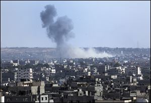 Smoke rises after an Israeli missile strike hit the northern Gaza Strip, Thursday, July 17, 2014. Gaza residents rushed to banks, vegetable markets and shops Thursday during a first U.N.-brokered lull in 10 days of Israel-Hamas fighting,