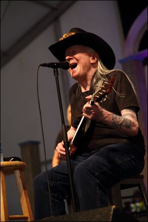 Johnny Winter performs at the New Orleans Jazz & Heritage Festival earlier this year.