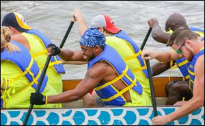 Patrick ‘‍P.J.’ Bolden, center, rows vigorously with his teammates from Medical Mutual.