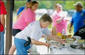 Marge Giznsky, Carleton, Mich., attends the Ohio Carry and Michigan Open Carry picnic in Pearson Metropark in Oregon.