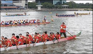 Dragon Boats hit the water during the 13th annual Dragon Boat Festival hosted by Partners in Education on Saturday at the Maumee River.