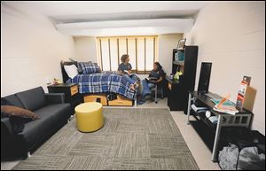 Dana Thomas, left, and Jewel Perry, right, sophomores at University of Toledo, sit in a remodeled single dorm room in MacKinnon Hall.