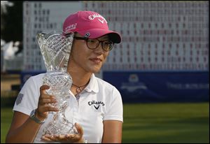 Lydia Ko holds her crystal trophy after winning the Marathon Classic presented by Owens Corning and O-I.