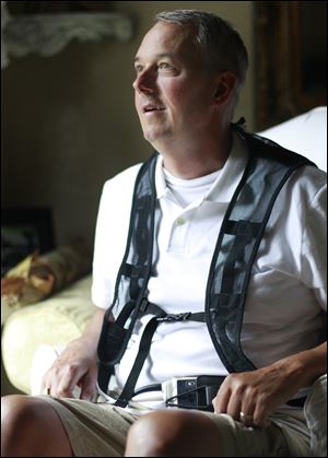 Mike Grieselding wears a mechanical device that pumps his heart. He had a heart attack in January.