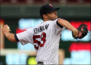 Minnesota Twins pitcher Kris Johnson throws against the Cleveland Indians in the first inning.