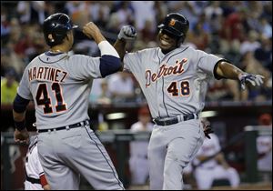 Detroit Tigers' Torii Hunter (48) celebrate his two run home run against the Arizona Diamondbacks with teammate Victor Martinez (41) during the first inning.