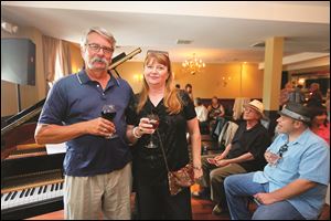 Jim Ferguson and Barb Farley have a glass of wine and chat before the benefit concert for Toledo Jazz Orchestra.