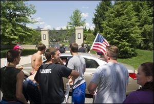 Cleveland Cavaliers basketball fans celebrate in front of the house of LeBron James, in Bath, Ohio, after learning of James' decision to sign as a free-agent with the Cavaliers on July 11.