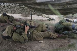 Israeli soldiers sleep near the border of  Israel and Gaza Strip.