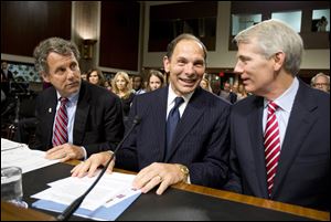 Veterans Affairs Secretary nominee Robert McDonald of Ohio is flanked by Sens. Sherrod Brown, (D., Ohio), left, and Rob Portman, (R., Ohio), right, ahead of a Senate Veterans' Affairs Committee hearings to examine his nomination to be Secretary of Veterans Affairs on Capitol Hill in Washington, Tuesday.