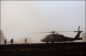 Israeli soldiers carry wounded soldier to a helicopter near the Israel and Gaza border today.