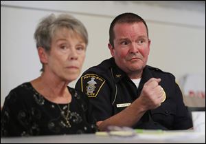 Mayor Margaret Scarpelli, left, listens as police Chief Ric Lampela makes a point during a public safety meeting at Put-in-Bay, Ohio.