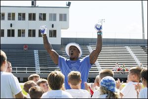 Tahir Whitehead talks to youth football campers on Thursday. Whitehead, a linebacker for the Lions, stressed the importance of having good character to the youth at the Sylvania camp.