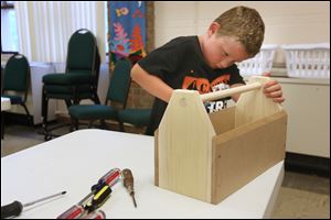 Gavin Ballard, 6, puts the finishing touches on a toolbox during Vacation Bible School.