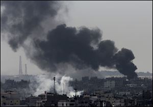 Smoke from Israeli strikes rises over Gaza City on Sunday in the northern Gaza Strip.