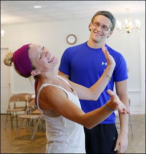 Deanna Welch, left, and Christian Siebenaler rehearse a scene from the Music Man with the Perrysburg Musical Theatre Company at  St. Timothy’s Church.
