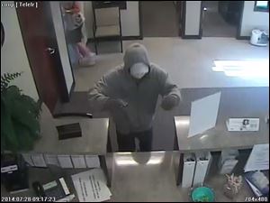 A photo of a suspect during a bank robbery this morning at the Toledo Co-Op Credit Union.