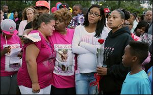 Oleen Clinton, right, attends a vigil Monday for her son, Tyler McIntoush, who was shot to death last week on Collingwood Boulevard. With her at the Maritime Academy is, from left, Jodi Johns, principal of the school; Denise McIntoush, Tyler’s grandmother, and Sierra Griswald, the slain youth’s sister. 