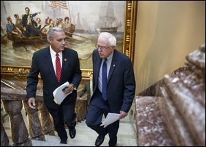 Senate Veterans’ Affairs Committee Chairman Sen. Bernie Sanders, I-Vt., right and House Veterans’ Affairs Committee Chairman Rep. Jeff Miller, R-Fla., take the stairs to a news conference on Capitol Hill, in Washington, Monday about a bipartisan deal to improve veterans' health care.