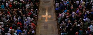 The crucifix reflected on the floor.