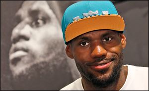 NBA star LeBron James speaks during a promotional event at a shopping district in Hong Kong as part of his China tour Wednesday, July 23, 2014. 